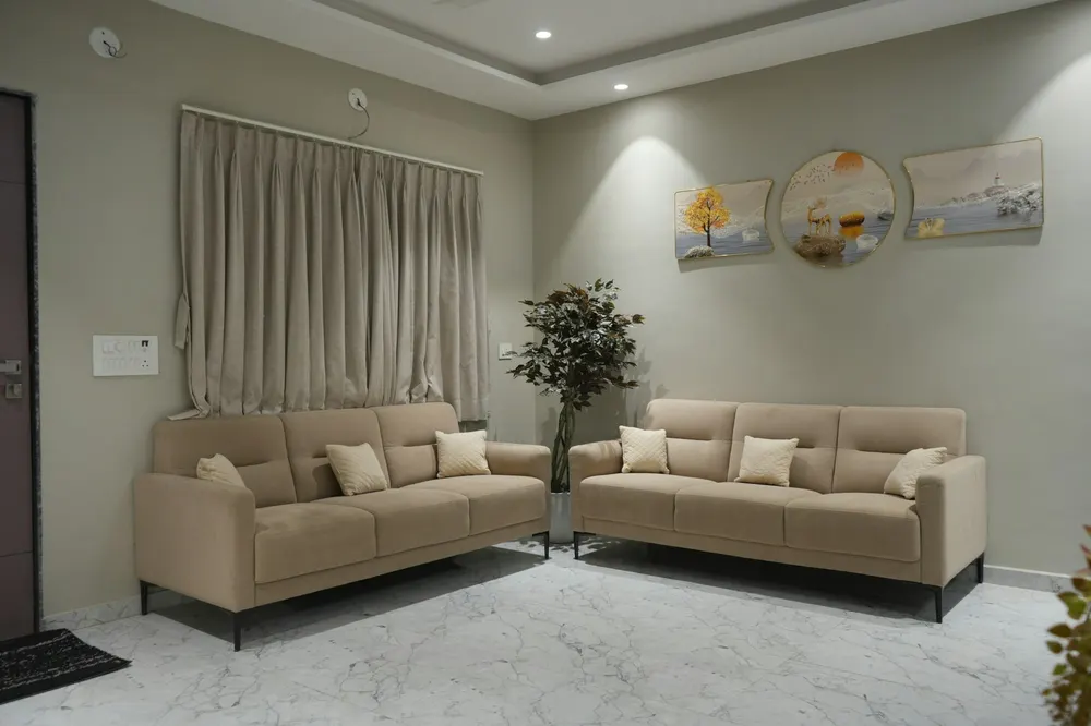 Before: a grey living room with two beige sofas