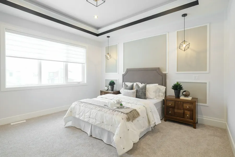 Before: new-build bedroom with white walls, grey moulding and beige carpet