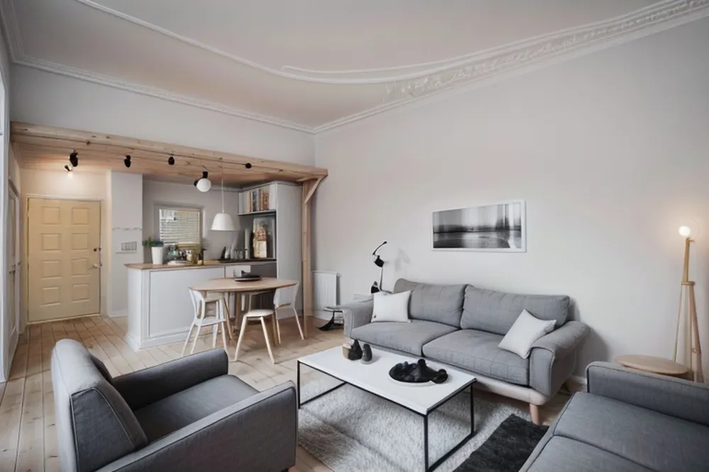 After: the same room with pale wood dining chairs, a light wood beam with track lights and a white coffee table